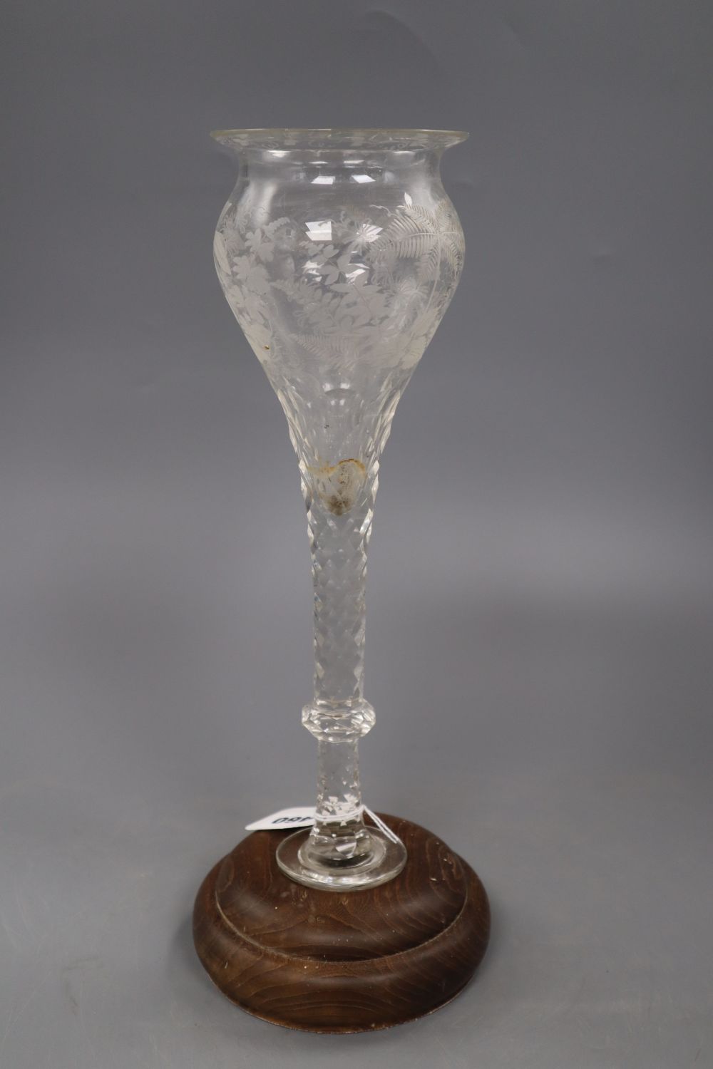 A facet cut glass vase on wooden base, total height 37cm